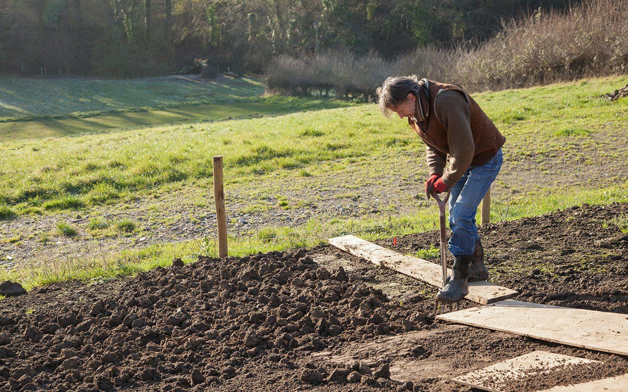 Dan Pearson digging over compacted ground in his Somerset garden